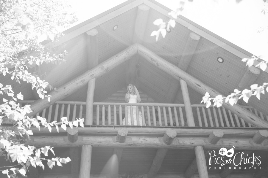 Beautiful wedding photo of bride on balcony, sun flare, The Gathering Place at Darlington Lake wedding photo, Wedding photo at lodge, www.PicsByChicksPhotography.com - Pittsburgh Wedding Photographer