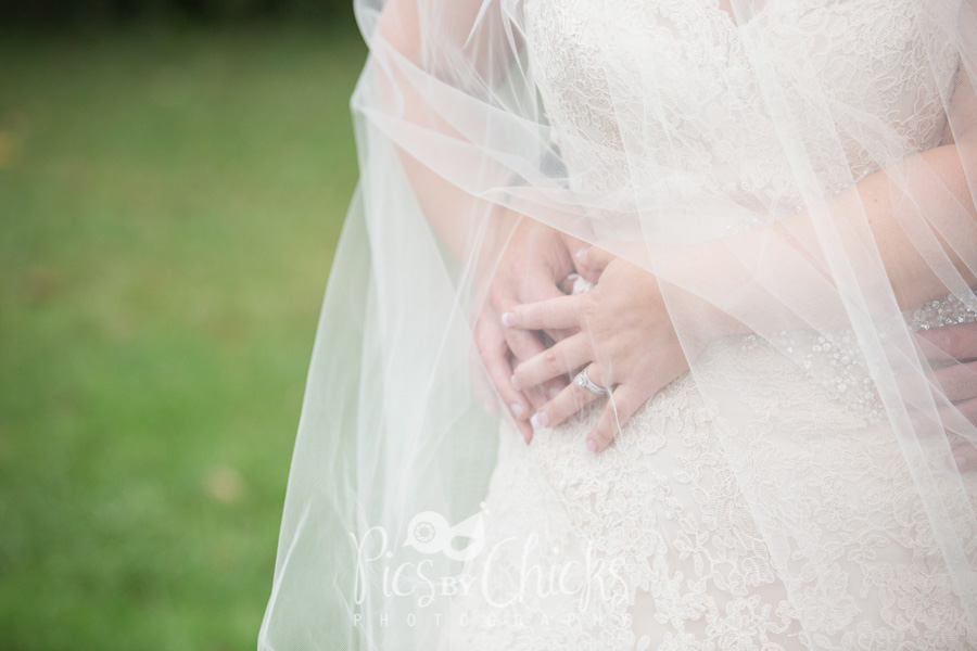 wedding detail photo of ring, lace dress and veil - Pics By Chicks Photography wedding detail photo of ring, lace dress and veil - Pics By Chicks Photography