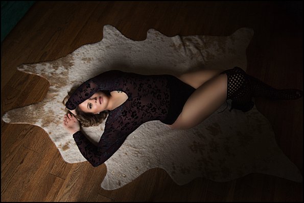 boudoir photos pittsburgh of woman in sexy boots laying on floor boudoir photos pittsburgh of woman in sexy boots laying on floor