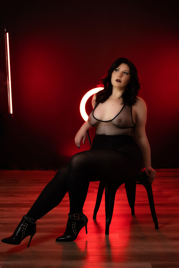 creative boudoir photography pittsburgh, self love photo shoot, lingerie photo with fishnet bodysuit and red neon lights
