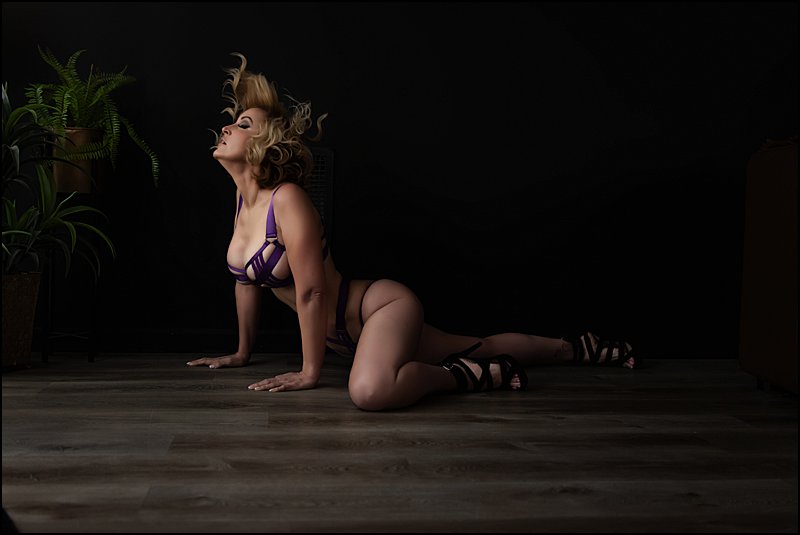 boudoir photography pittsburgh, sexy photo shoot pittsburgh, purple lingerie posing on floor at boudoir studio Maura Chick Studios