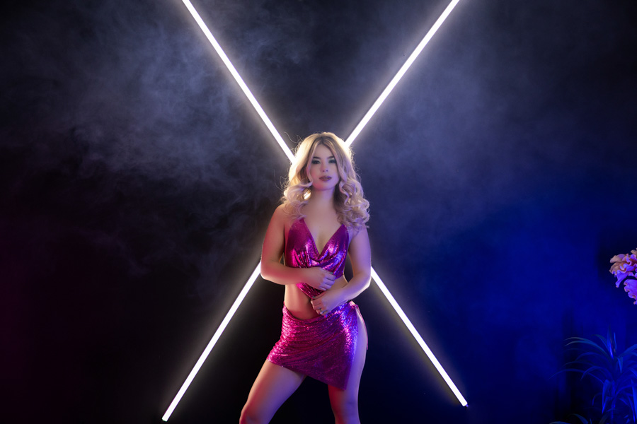 strong and confidence photo shoot for women, pittsburgh boudoir studio with Maura Chick, x light design with woman in pink chainmail lingerie